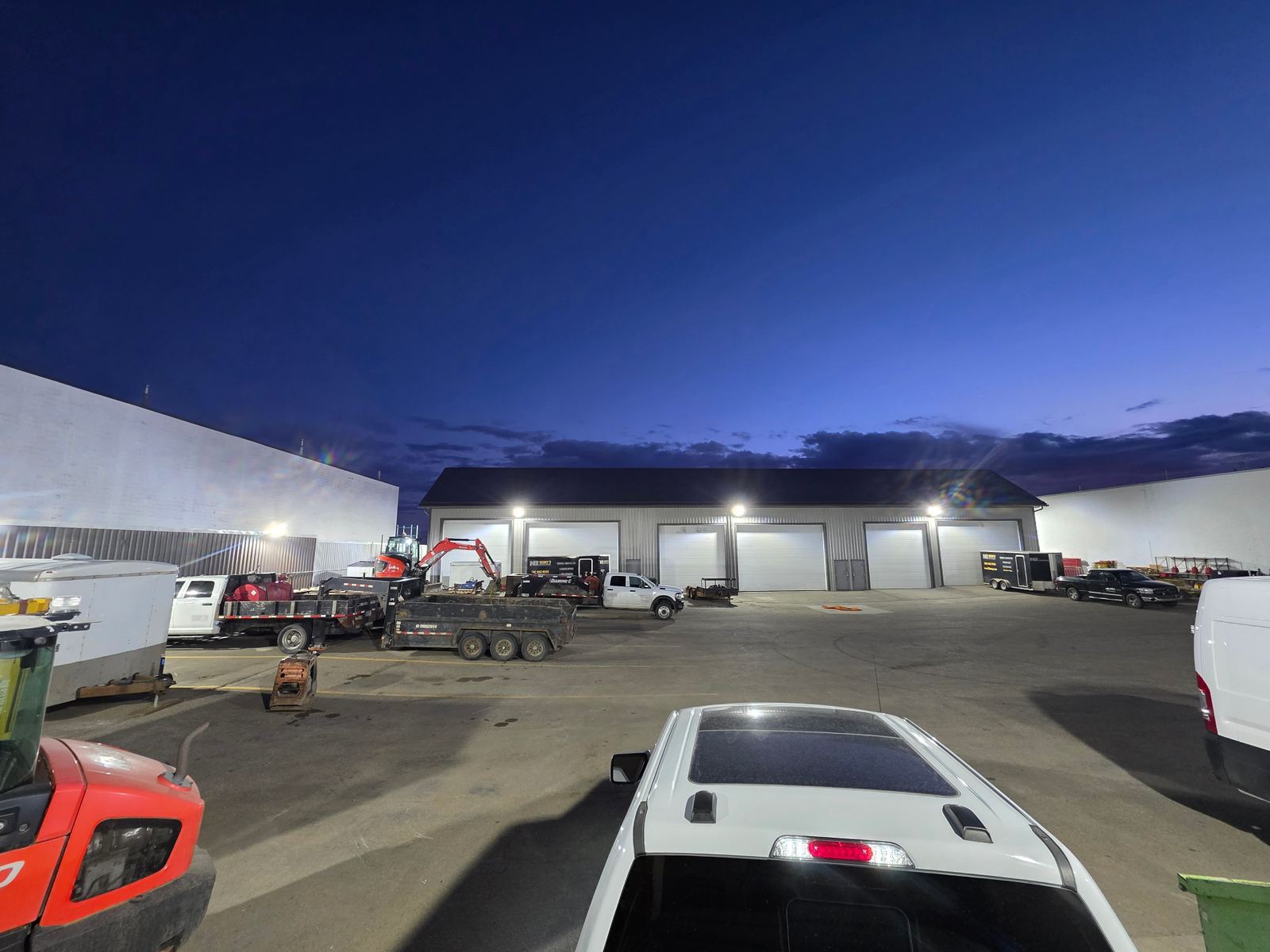Commercial yard at dusk illuminated by new exterior LED lighting